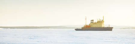 Icebreaker close-up. White Sea, Polar Circle, Russia. Ice texture. Concept winter landscape....