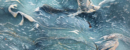 Beautiful blue stone and pebble texture, close-up. Scotland, UK. Sea water background. Natural...