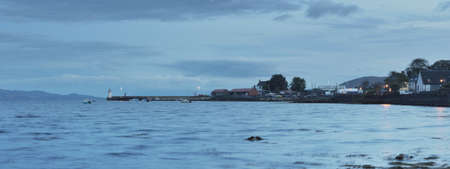 Panoramic view of the lake shores, valleys, hills and forests under ornamental stormy clouds....