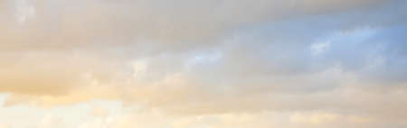 Clear blue sky. glowing pink and golden cirrus and cumulus clouds after storm, soft sunlight....