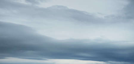 Ornamental clouds. Dramatic sky. Epic storm cloudscape. Soft sunlight. Panoramic image, texture,...