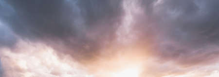 Clear blue sky. glowing pink and golden cirrus and cumulus clouds after storm, soft sunlight....