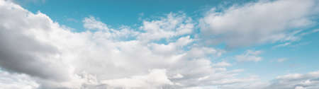 Ornamental clouds. Dramatic sky. Epic storm cloudscape. Soft sunlight. Panoramic image, texture, background, graphic resources, design, copy space. Meteorology, heaven, hope, peace conceptの写真素材