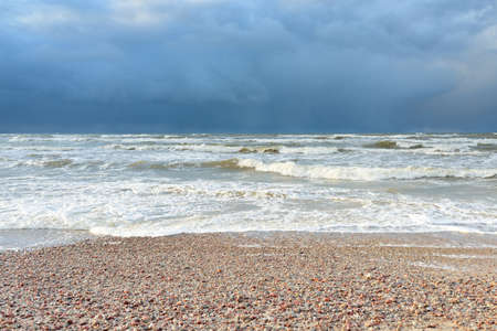 Baltic sea shore (sand dunes, beach) after the storm. Dramatic sky, glowing clouds. Picturesque panoramic scenery. Nature, environment, ecology, ecotourism, hiking, exploring conceptsの写真素材