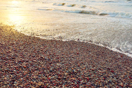 Baltic sea shore at sunset. Beach, sand dunes. Dramatic sky flowing clouds. Soft sunlight. Nature,...