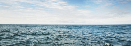 A view of the stormy North sea from a sailing boat. Cloudy blue sky reflecting in the water....