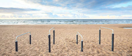 An empty modern rest area on the sandy shore of the Baltic sea. Sport, recreation, cycling, nordic walking, relaxation, vacations, weekend, tourism, leisure activityの写真素材