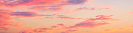 Clear blue sky, red, pink, golden cirrus and cumulus clouds after storm. Dramatic sunset cloudscape....