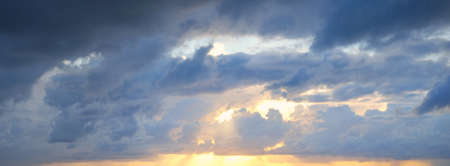 Clear blue sky. glowing pink and golden cirrus and cumulus clouds after storm, soft sunlight....