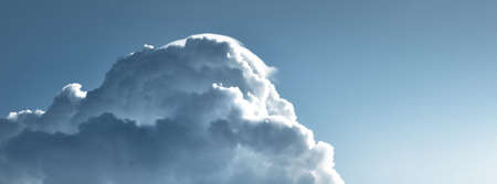 Epic storm cloudscape. White ornamental sunset cumulus clouds. Soft sunlight, sun rays. Clear blue...