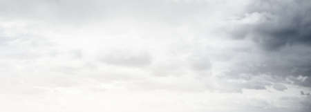 Ornamental clouds. Dramatic sky. Epic storm cloudscape. Soft sunlight. Panoramic image, texture, background, graphic resources, design, copy space. Meteorology, heaven, hope, peace conceptの写真素材