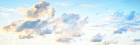 Clear blue sky, red, pink, golden cirrus and cumulus clouds after storm. Dramatic sunset cloudscape. Concept art, meteorology, heaven, hope, peace, graphic resources, picturesque panoramic sceneryの写真素材