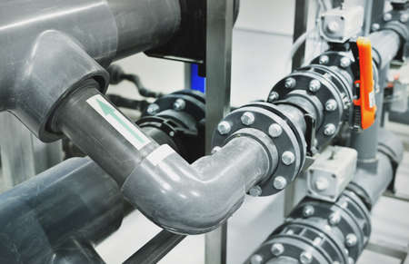 PVC pipeline an industrial city water treatment boiler room. Valves and pipe connections....