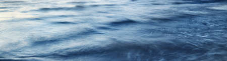 Sea water surface texture. Soft sunlight. Panoramic image, graphic resources. Nature, environment conceptsの写真素材