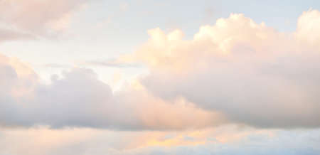 Ornamental clouds. Dramatic sky. Epic storm cloudscape. Soft sunlight. Panoramic image, texture, background, graphic resources, design, copy space. Meteorology, heaven, hope, peace conceptの写真素材