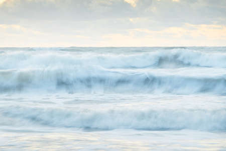 Sea waves and splashes texture. Colorful sky reflecting in the water. Idyllic seascape. Concept...