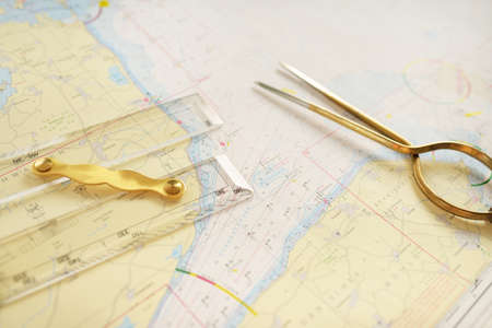 Antique W HC 6" brass dividers calipers nautical navigation chart tool, parallel ruler, white map close-up. Vintage still life. Sailing, travel accessories. Planning, concept artの写真素材