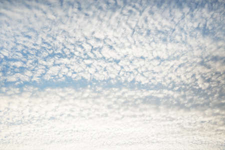 Coudscape. White ornamental clouds. Soft sunlight, sunbeams. Clear blue sky. Natural pattern,...
