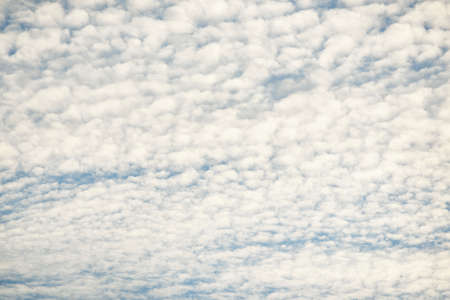 Coudscape. White ornamental clouds. Soft sunlight, sunbeams. Clear blue sky. Natural pattern,...