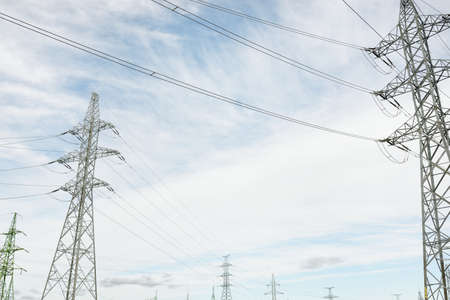 Electricity power line. Dramatic sky. Concept urban landscape. Energy, power generation, equipment, industry, environmental damage, pollution, ecology, supply, infrastructureの写真素材