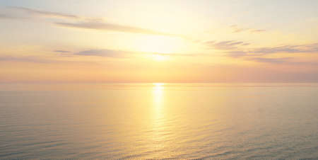 Baltic sea at sunset. Dramatic sky, blue and pink glowing clouds, soft golden sunlight, midnight sun. Picturesque dreamlike seascape, cloudscape, nature. Panoramic viewの写真素材