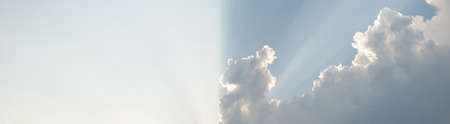 Epic storm cloudscape. White ornamental sunset cumulus clouds. Soft golden sunlight. Clear blue sky....