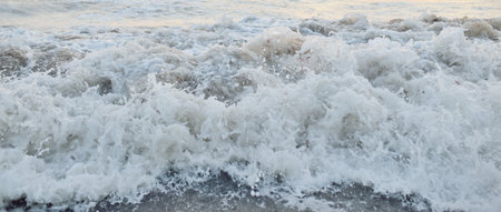 Baltic sea after the storm at sunset. Water surface texture, waves and splashes. Picturesque...