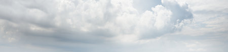 Ornamental clouds. Dramatic sky. Epic storm cloudscape. Soft sunlight. Panoramic image, texture,...