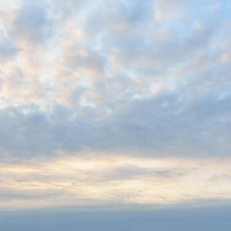 Clear blue sky with glowing cirrus and cumulus clouds after the storm at sunset. Dramatic...