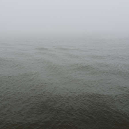 Baltic sea in a fog. Waves, splashing water, storm. Natural textures. Picturesque panoramic...