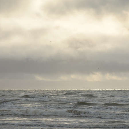 Baltic sea after the storm. Soft sunset light, dramatic glowing clouds. Seascape, cloudscape,...
