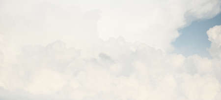 Ornamental clouds. Dramatic sky. Epic storm cloudscape. Soft sunlight. Panoramic image, texture, background, graphic resources, design, copy space. Meteorology, heaven, hope, peace conceptの写真素材