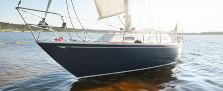 Blue sloop rigged yacht anchored to the sandy shore (beach). Sailing in Sweden, Europe. Nature,...