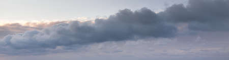 Clear blue sky. glowing pink and golden cirrus and cumulus clouds after storm, soft sunlight....