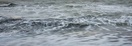 Baltic sea in a fog. Waves, splashing water, storm. Natural textures. Picturesque panoramic...