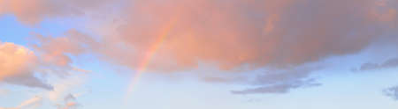 Clear blue sky. glowing pink, golden cirrus and cumulus clouds after storm, soft sunlight. Sunset cloudscape. Meteorology, midnight sun, heaven, peace, graphic resources, picturesque panoramic sceneryの写真素材