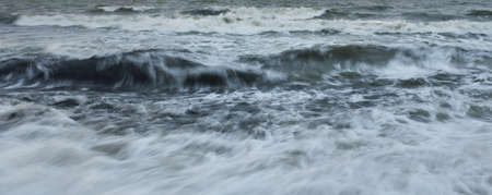 Baltic sea in a fog. Waves, splashing water, storm. Natural textures. Picturesque panoramic...
