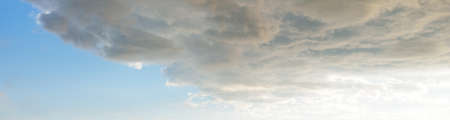Ornamental clouds. Dramatic sky. Epic storm cloudscape. Soft sunlight. Panoramic image, texture,...