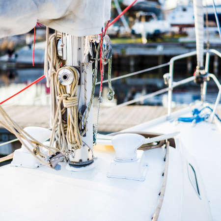 Sailboat moored to a pier in a yacht marina after winterization. Vacations, transportation, sport, recreation, tourism, cruise, port serviceの写真素材