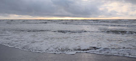 Baltic sea after the storm. Soft sunset light, dramatic glowing clouds. Seascape, cloudscape,...