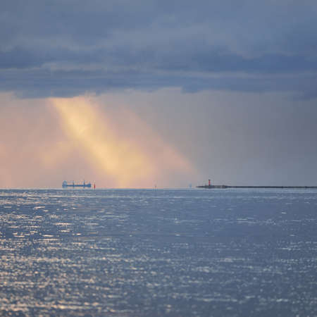 Baltic sea after the storm, panoramic view from a sailing boat. Dramatic sunset sky. Glowing clouds,...