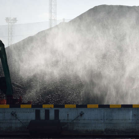 Modern coal terminal in Riga, Latvia. Cranes close-up. Baltic sea. Freight transportation, logistics, global communications, economy, business, industry, supply, special equipment. Urban landscapeの写真素材