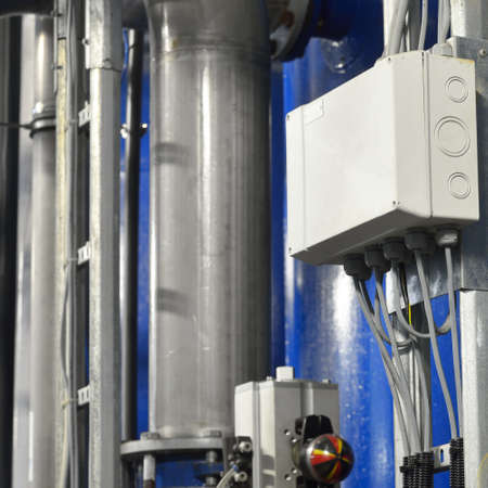 Industrial water treatment and boiler room. Shiny steel metal pipes, piping, connections. Industry, technology, biotechnology, chemistry, heating, work safety, special equipment. Panoramic viewの写真素材