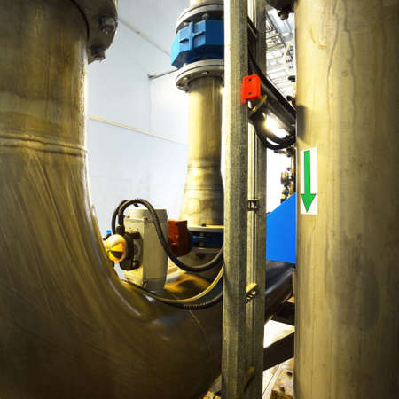 Industrial water treatment and boiler room. Shiny steel metal pipes, piping, connections. Industry,...