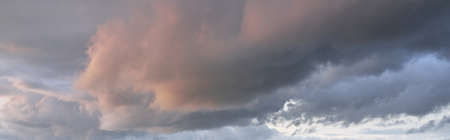 Epic storm cloudscape. Dark ornamental sunset cumulus clouds. Natural pattern, texture, background,...