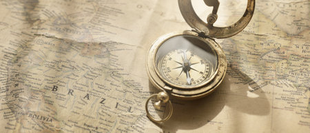 Retro style antique golden compass (sundial) and old nautical chart close-up. Vintage still life....