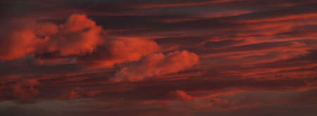 Sunset sky, glowing pink and golden clouds after the storm. Dramatic cloudscape. Concept art,...