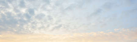Clear blue sky with glowing cirrus and cumulus clouds after the storm at sunset. Dramatic...