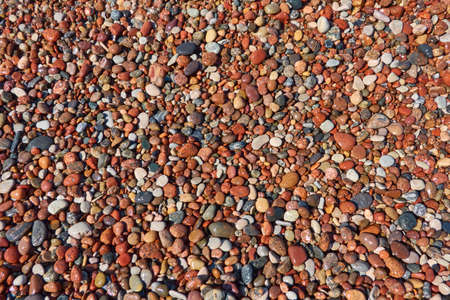 Wet pebble stones. Seashore, beach. Natural texture, background, wallpaper, pattern. Concept summer scene. Nature, environment, vacations, relaxation, meditation conceptsの写真素材
