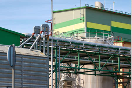 Modern grain elevator in cargo port. Ventspils, Latvia. Concept urban landscape. Nature, ecology,...